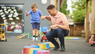 A young man work as a child carer at a nursery
