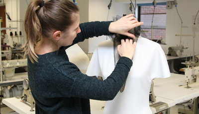 Student making clothing on a mannequin